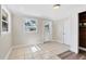 Laundry room with tile floor, door to outside, and wood shelving at 2040 Palm Ter, Sarasota, FL 34231