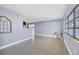 Open living room with light walls, terrazzo floors, and kitchen view at 2040 Palm Ter, Sarasota, FL 34231