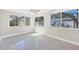 Bright sunroom with multiple windows and terrazzo flooring at 2040 Palm Ter, Sarasota, FL 34231