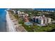 Aerial view of condos near the beach, a pool, and beautifully kept grounds at 2089 Gulf Of Mexico Dr # G1-205, Longboat Key, FL 34228