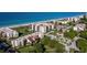 An aerial view of the condominiums near the beach and beautiful blue water at 2089 Gulf Of Mexico Dr # G1-205, Longboat Key, FL 34228