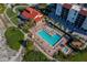 Aerial view of the pool and multiple hot tubs, beach access and building at 2089 Gulf Of Mexico Dr # G1-205, Longboat Key, FL 34228