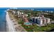 Breathtaking aerial view of a condo community with manicured grounds, a pool, and ocean access at 2089 Gulf Of Mexico Dr # G1-205, Longboat Key, FL 34228