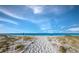 Community Beach with a winding path, clear blue skies and views of the ocean. The perfect escape at 2089 Gulf Of Mexico Dr # G1-205, Longboat Key, FL 34228