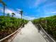 Enjoy this winding beach path with lush greenery and sandy steps to get to the beautiful ocean at 2089 Gulf Of Mexico Dr # G1-205, Longboat Key, FL 34228