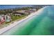 Expansive aerial shot of a beach, coastline, condos and construction in the distance at 2089 Gulf Of Mexico Dr # G1-205, Longboat Key, FL 34228