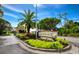 Community sign and lush landscaping at the gated community entrance at 2089 Gulf Of Mexico Dr # G1-205, Longboat Key, FL 34228