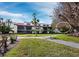 Beautiful view of the condo building with screened patios and lush green landscape at 2089 Gulf Of Mexico Dr # G1-205, Longboat Key, FL 34228