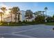 Beautiful condo complex with lush landscaping, palm trees, and well maintained green spaces at 2089 Gulf Of Mexico Dr # G1-205, Longboat Key, FL 34228