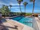 Inviting hot tub with lush landscaping and palm trees on a bright, sunny day at 2089 Gulf Of Mexico Dr # G1-205, Longboat Key, FL 34228