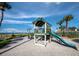 Community playground near the beach with a small slide and swing set at 2089 Gulf Of Mexico Dr # G1-205, Longboat Key, FL 34228