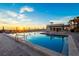 Beautiful pool featuring lounge chairs and umbrellas, overlooking an ocean sunset at 2089 Gulf Of Mexico Dr # G1-205, Longboat Key, FL 34228