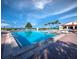 Stunning view of the bright blue community pool with lounge chairs and umbrellas for shaded comfort at 2089 Gulf Of Mexico Dr # G1-205, Longboat Key, FL 34228