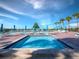 Bright community pool with comfortable lounge chairs and shaded umbrellas and clear blue water at 2089 Gulf Of Mexico Dr # G1-205, Longboat Key, FL 34228