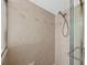 Neutral-toned shower with decorative tiles and a glass door at 2089 Gulf Of Mexico Dr # G1-205, Longboat Key, FL 34228