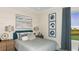 Bright bedroom with golf course views and a teal accent wall at 26848 Dove Dr, Punta Gorda, FL 33955