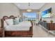 Beautiful bedroom features a decorative chandelier, TV, and scenic water view at 272 Saint Lucia Dr # 101, Bradenton, FL 34209