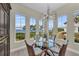 Dining area with water views, a glass top table, and decorative chairs under a modern lighting fixture at 272 Saint Lucia Dr # 101, Bradenton, FL 34209