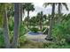 Hammock hung between tropical palm trees at 272 Saint Lucia Dr # 101, Bradenton, FL 34209