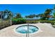 Inviting hot tub surrounded by a brick patio and mature landscaping for privacy at 272 Saint Lucia Dr # 101, Bradenton, FL 34209