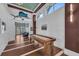 Hallway with dark wood floors and accents, leading to a seating area and featuring a shuffleboard table at 272 Saint Lucia Dr # 101, Bradenton, FL 34209