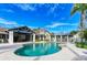 Community pool with outdoor kitchen, seating, and sunbathing area at 272 Saint Lucia Dr # 101, Bradenton, FL 34209