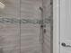 Tiled shower features a rainfall shower head and designer accents at 272 Saint Lucia Dr # 101, Bradenton, FL 34209