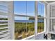 Stunning water view from large windows with white shutters, offering natural light at 272 Saint Lucia Dr # 101, Bradenton, FL 34209