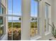 Three windows with views of the waterfront and natural greenery in an elegant room at 272 Saint Lucia Dr # 101, Bradenton, FL 34209