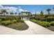 A vibrant community garden with lush plants and a wooden pergola entrance at 3023 Vittorio Ct, Lakewood Ranch, FL 34211