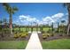 Well-maintained dog park with secure fencing and open space, features lush landscaping and shaded bench at 3023 Vittorio Ct, Lakewood Ranch, FL 34211