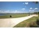 Scenic view of the community's golf course with blue skies and golfers practicing their swing at 3023 Vittorio Ct, Lakewood Ranch, FL 34211