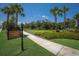 Scenic view of Vitality Park, featuring lush greenery, paved pathway, and welcoming signage at 3023 Vittorio Ct, Lakewood Ranch, FL 34211