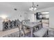 Dining room with modern table, chairs, and bench seating, next to a cabinet and kitchen at 3050 Lake Bayshore Dr # O-108, Bradenton, FL 34205