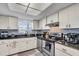 Well-lit kitchen featuring stainless steel appliances, granite counters and a decorative backsplash at 3050 Lake Bayshore Dr # O-108, Bradenton, FL 34205