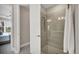 Beautifully tiled shower with glass door and a doorway leading to the main bedroom at 3105 Formia Ct, Bradenton, FL 34211