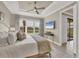 Spacious bedroom with a ceiling fan, luxury decor and a door leading to another room at 3105 Formia Ct, Bradenton, FL 34211