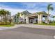 Elegant community center entrance with a porte cochere, lush landscaping and manicured lawn at 3105 Formia Ct, Bradenton, FL 34211