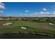 Scenic view of the manicured golf course with lush green grass, sand traps, and a tranquil pond at 3105 Formia Ct, Bradenton, FL 34211