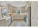 Well-lit kitchen with stainless steel appliances, farmhouse sink, and ample cabinet space at 3105 Formia Ct, Bradenton, FL 34211