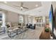 Inviting living room open to the kitchen featuring stylish furniture and an entertainment center at 3105 Formia Ct, Bradenton, FL 34211