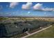 Aerial view of tennis and pickleball courts with shade structures, landscaping, and fencing at 3105 Formia Ct, Bradenton, FL 34211