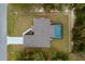 Overhead view of the home highlighting the roof, screened pool, driveway, and landscaped yard at 336 Milford St, Port Charlotte, FL 33953