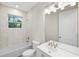 Bathroom with white tile, large window and vanity with a mirror at 336 Milford St, Port Charlotte, FL 33953