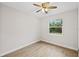 Bedroom featuring wood-look floors and a view of the backyard through a large window at 336 Milford St, Port Charlotte, FL 33953