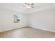 Serene bedroom with wood-look tile, a window offering natural light, and a ceiling fan at 336 Milford St, Port Charlotte, FL 33953