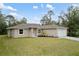 Attractive home with a lush green lawn, showcasing its neutral color scheme, and curb appeal at 336 Milford St, Port Charlotte, FL 33953