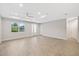 Inviting living room with wood-look tile, abundant natural light, and a tray ceiling with ceiling fan at 336 Milford St, Port Charlotte, FL 33953