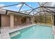 Screened-in pool with paver patio is perfect for outdoor entertaining and enjoying the Florida weather at 336 Milford St, Port Charlotte, FL 33953