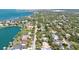 This aerial shot shows a cozy home nestled within a picturesque, tree-lined neighborhood at 3705 Tangier Ter, Sarasota, FL 34239